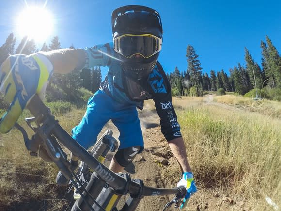 A person using a GoPro mounted camera on their mountain bike.