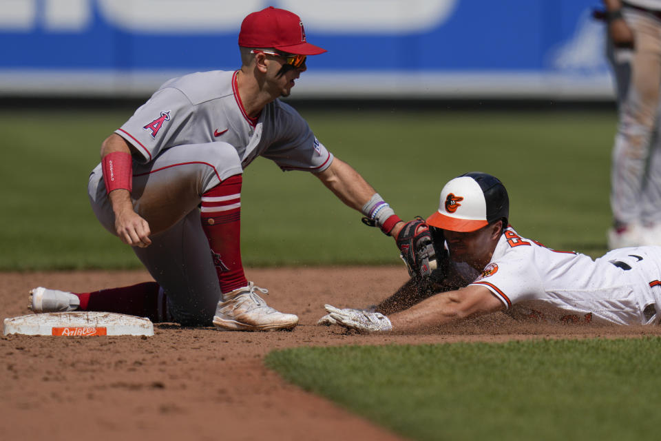 Los Angeles Angels shortstop Zach Neto, left, tags out Baltimore Orioles' Adam Frazier, right, during the ninth inning of a baseball game at Oriole Park at Camden Yards, Thursday, May 18, 2023, in Baltimore. The Angels won 6-5. (AP Photo/Jess Rapfogel)