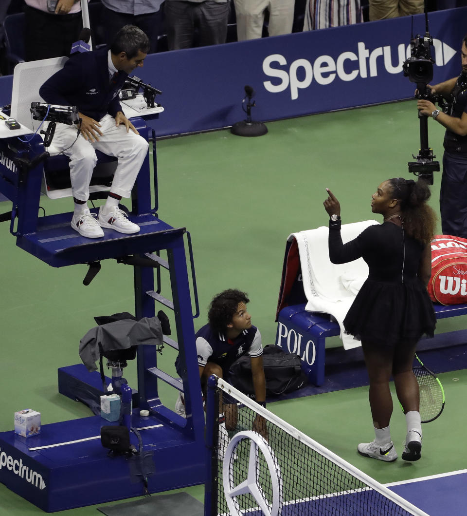 Serena Williams talks with chair umpire Carlos Ramos after being defeated by Naomi Osaka, of Japan, in the women's final of the U.S. Open tennis tournament, Saturday, Sept. 8, 2018, in New York. (AP Photo/Seth Wenig)