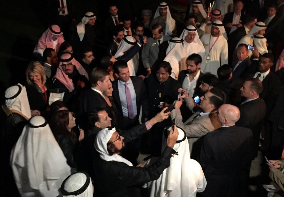 Eric (C-L) and Donal Jr (C-R) Trump, the sons of the US president, pose for selfies with guests during the inauguration ceremony of the Trump International Golf Club in Dubai on February 18, 2017. The American president's sons opened the Trump International Golf Club as Dubai hosted the first foreign launch of a venue bearing Donald Trump's name since he took office. (Photo by Natacha YAZBECK / AFP) (Photo by NATACHA YAZBECK/AFP via Getty Images)