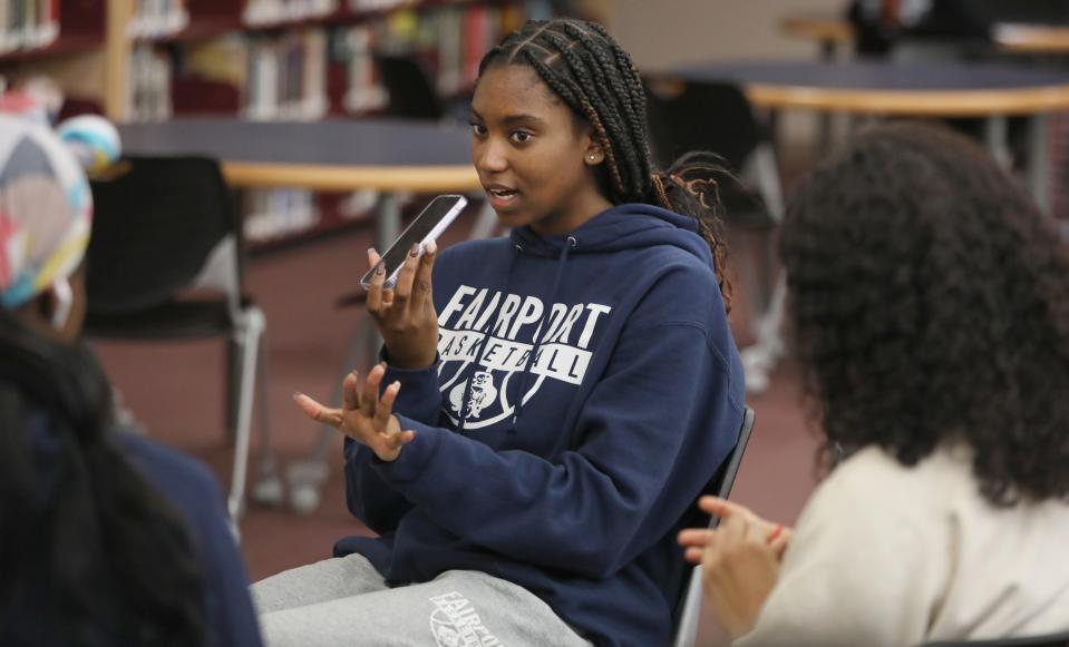 Black Student Union president Jada Crocker, a junior at Fairport High School, uses her smart phone to interview classmates for a podcast during a meeting of the Black Student UnionThursday, March 23, 2023 at Fairport High. 