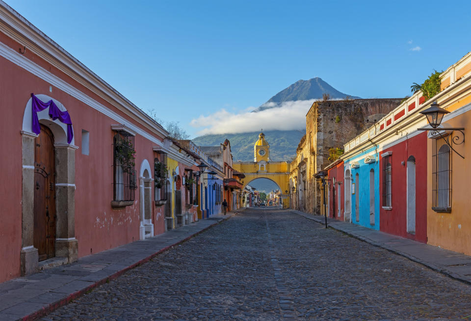 Colorful houses with a volcano in the background