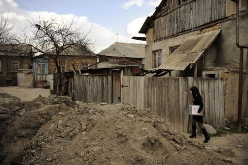 A member of a local electoral commission carries a ballot box during a vote in Tskhinvali, the capital of Georgia's maverick region of South Ossetia, on April 8, 2012. Sunday's vote marked the third attempt since November to elect a leader amid political turmoil in the region, which Russia recognised as an independent state after driving out Georgian forces during a brief war in 2008