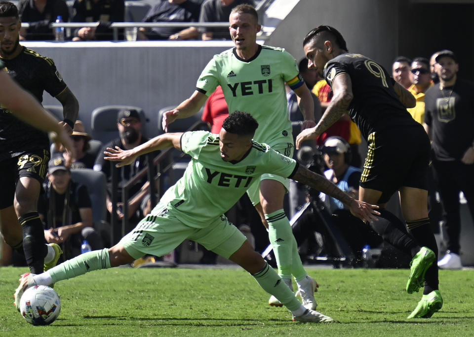 Austin FC midfielder Daniel Pereira, left, takes the ball from Los Angeles FC forward Cristian Arango (9) during the first half of an MLS playoff Western Conference final soccer match Sunday, Oct. 30, 2022, in Los Angeles. (AP Photo/John McCoy)