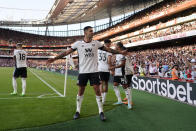 Fulham's Aleksandar Mitrovic, centre, celebrates after scoring his side's opening goal during the English Premier League soccer match between Arsenal and Fulham at the Emirates Stadium, London, England, Saturday, Aug. 27, 2022. (AP Photo/Alberto Pezzali)