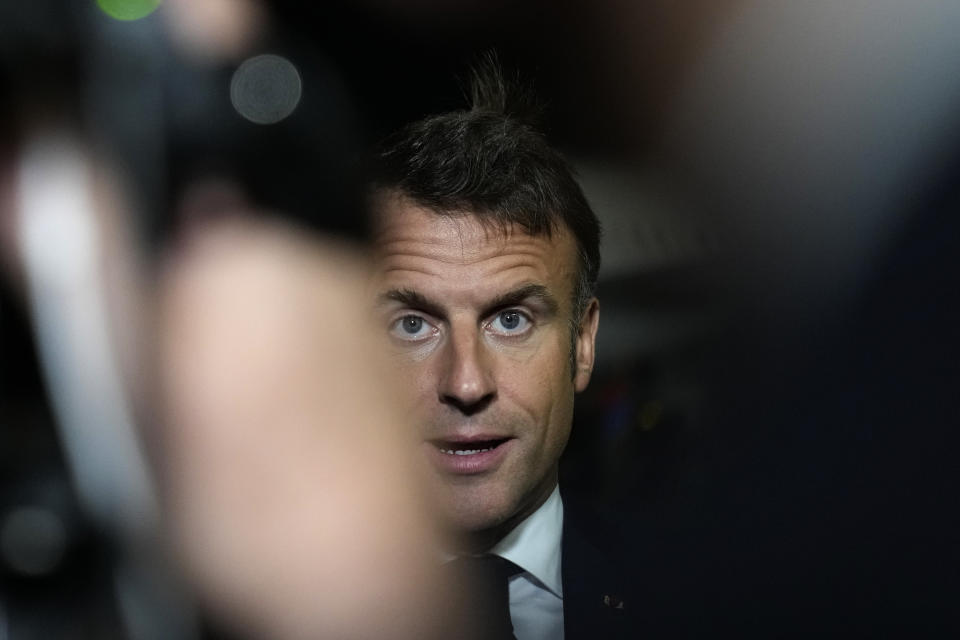 French President Emmanuel Macron talks to journalists on the tarmac of Cairo airport, Egypt, as he departs Wednesday, Oct. 25, 2023. French President Emmanuel Macron sought to promote, yet with little success, the prospect of creating an "international coalition" to fight against the armed Palestinian militant group Hamas, during a two-day trip to the Middle East that started in Israel. (AP Photo/Christophe Ena, Pool)