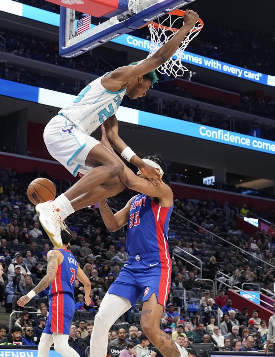 Charlotte Hornets forward Kai Jones (23) dunks on Detroit Pistons forward Marvin Bagley III (35) during the second half of an NBA basketball game, Thursday, March 9, 2023, in Detroit. (AP Photo/Carlos Osorio)