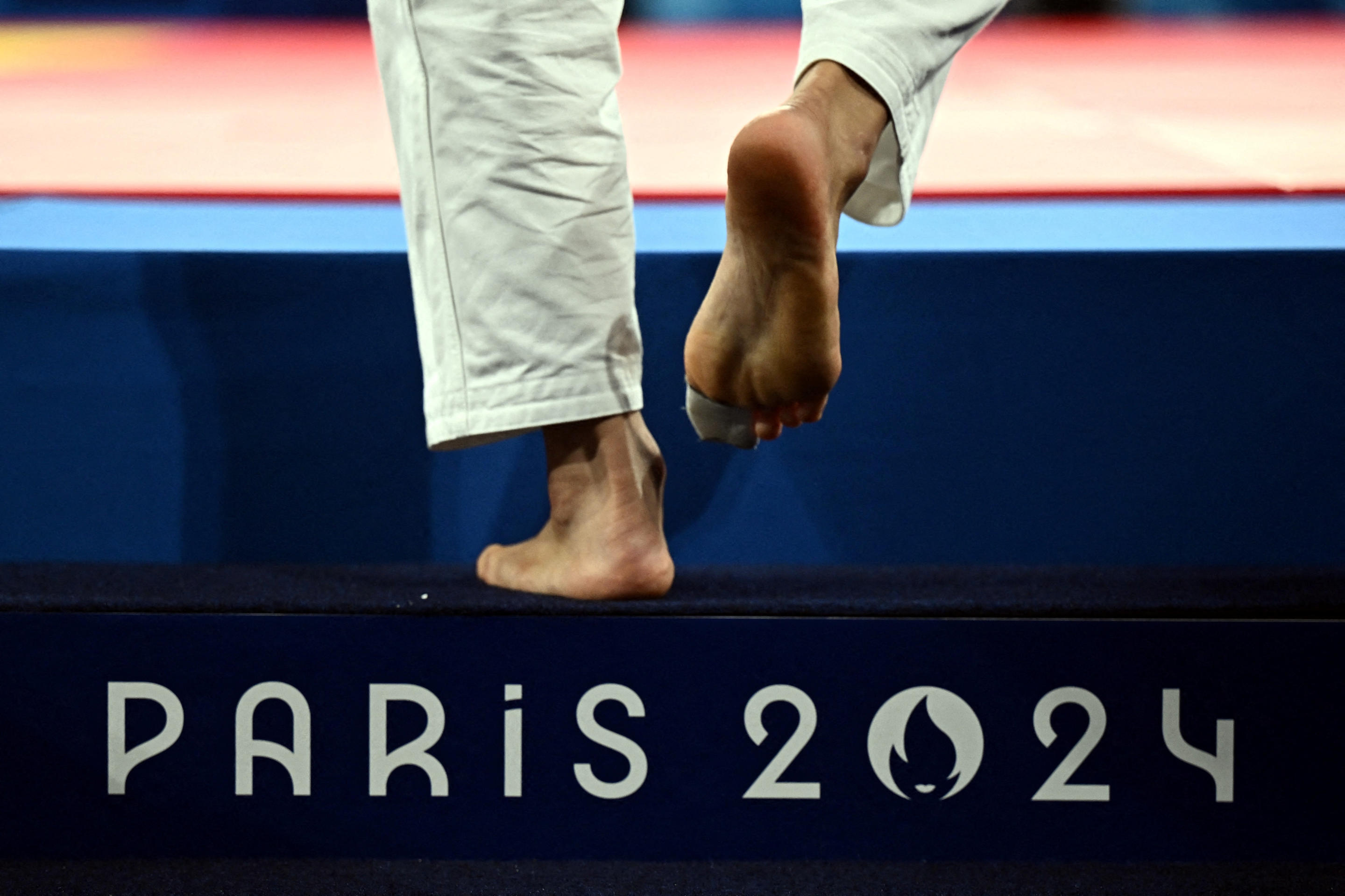 General view of Paris 2024 on a step as Soichi Hashimoto of Japan's feet are seen during his bout against Akil Gjakova of Kosovo during the  Judo - Men -73 kg Contest for Bronze Medal B on July 29, 2024. (Arlette Bashizi/Reuters)   