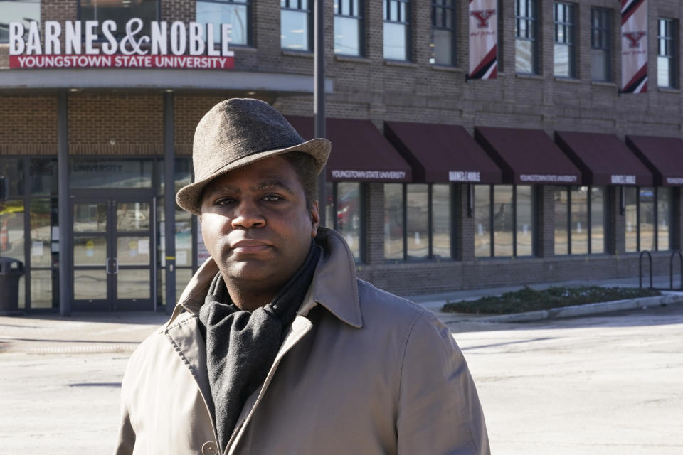 Andre Brady poses for a photo outside the Barnes & Noble, Thursday, Jan. 21, 2021, in Youngstown, Ohio. On its surface, the story of Brady's fight to keep his well-paying union job at a public university bookstore that was privatized isn't unique. Hundreds of workers have watched as their positions at once-independent college bookstores disappeared in recent years as operations were transferred to national book retailing giants. What makes the Ohio man's case notable is that it created a five-year paper trail that provides rare detail on the handover of the store from Youngstown State University to Barnes & Noble. (AP Photo/Tony Dejak)