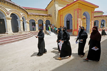 Veiled Muslim women leave after casting their vote at a polling station during the fifth phase of the general election in Ayodhya, May 6, 2019. REUTERS/Pawan Kumar