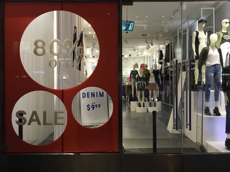 tAn H&M store has sale signs in the window in New York City