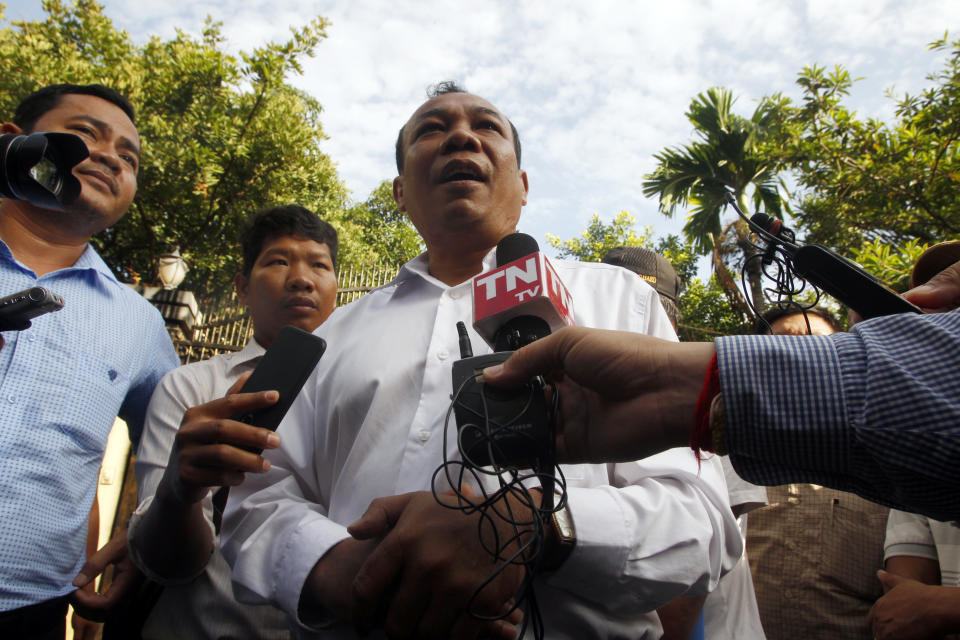 Chan Chen, center, lawyer to Kem Sokha, former leader of now dissolved opposition Cambodia National Rescue Party, talks with the media in front of his home in Phnom Penh, Cambodia, Monday, Sept. 10, 2018. Kem Sokha was released on bail Monday after being jailed for a year on a treason charge, a government spokesman said. A small crowd has gathered outside his home in Phnom Penh but so far he hasn’t been seen. His whereabouts are, as yet, unclear. (AP Photo/Heng Sinith)