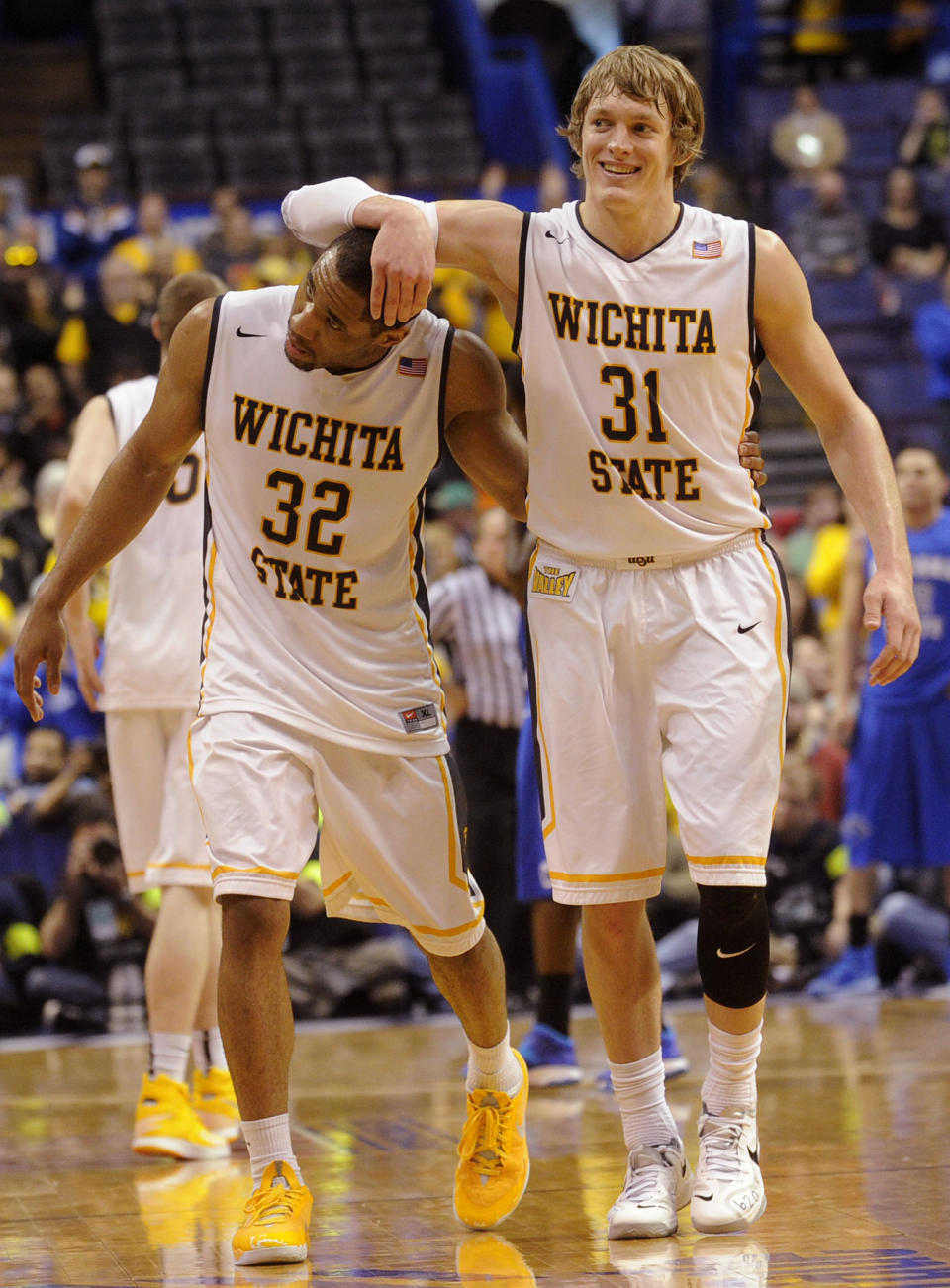 Wichita State's Ron Baker (31) and Tekele Cotton (32) celebrate late in the second half of an NCAA college basketball game against Indiana State for the championship of the Missouri Valley Conference Sunday, March 9, 2014, in St. Louis. (AP Photo/Bill Boyce)