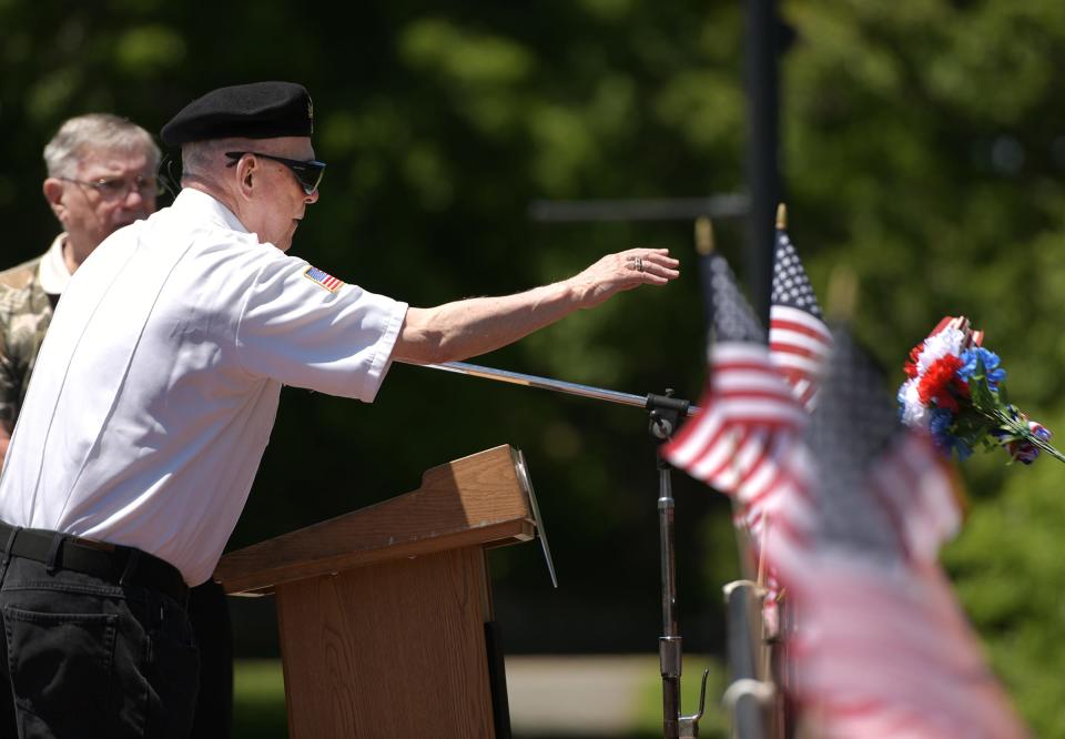 Veteran Frank Bonczek Jr. tosses a bouquet into the water Sunday at Elm Park to remember his brother and fellow veteran, Thomas Bonczek, during the Veteran's Council and City of Worcester Veterans' Services Department annual Water Ceremony in observance of Memorial Day.