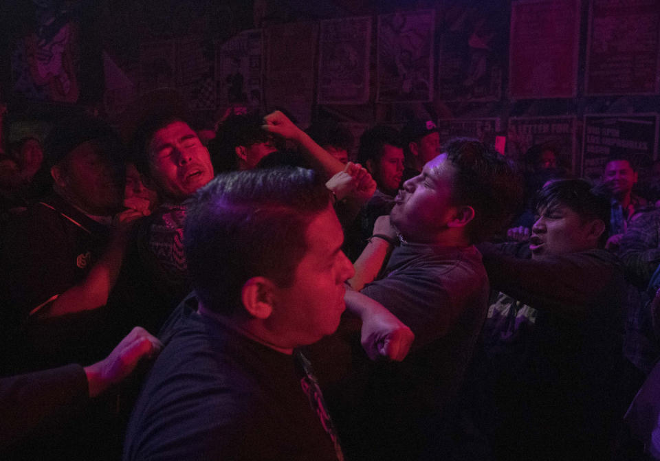 Fans of the Mexican Ska band Nana Pancha jump into the mosh pit during one of the last active weekends at the iconic counterculture venue Multiforo Alicia in Mexico City, Friday, Feb. 10, 2023. The space was inspired by the leftist self-managed occupied social centers in Italy in the 1980s and similar spaces called gaztetxes in the Basque Country, an autonomous region in Spain. (AP Photo/Eduardo Verdugo)