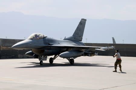 FILE PHOTO: A U.S. Air Force crew chief signals the pilot of an F-16 Flying Falcon as it taxis for a mission at Bagram air field in Afghanistan August 11, 2016. REUTERS/Josh Smith