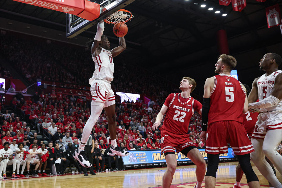 Feb 10, 2024; Piscataway, New Jersey, USA; Rutgers Scarlet Knights center Clifford Omoruyi (11) dunks the ball against Wisconsin Badgers forward Steven Crowl (22) and forward Tyler Wahl (5) during the second half at Jersey Mike’s Arena. Mandatory Credit: Vincent Carchietta-USA TODAY Sports