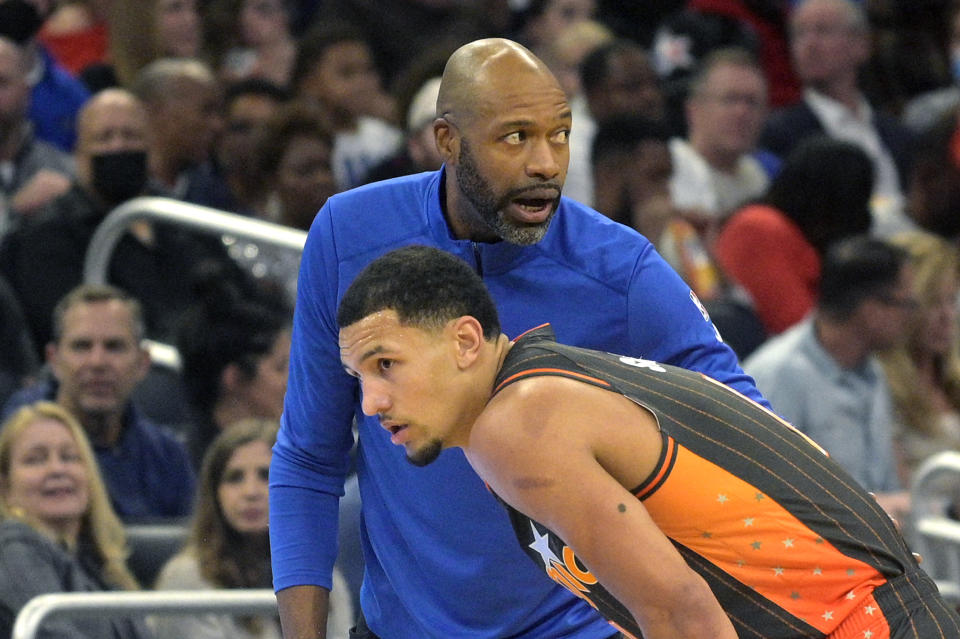 Orlando Magic head coach Jamahl Mosley, top, gives instructions to guard Jalen Suggs during the first half of an NBA basketball game against the Chicago Bulls, Friday, Nov. 26, 2021, in Orlando, Fla. (AP Photo/Phelan M. Ebenhack)