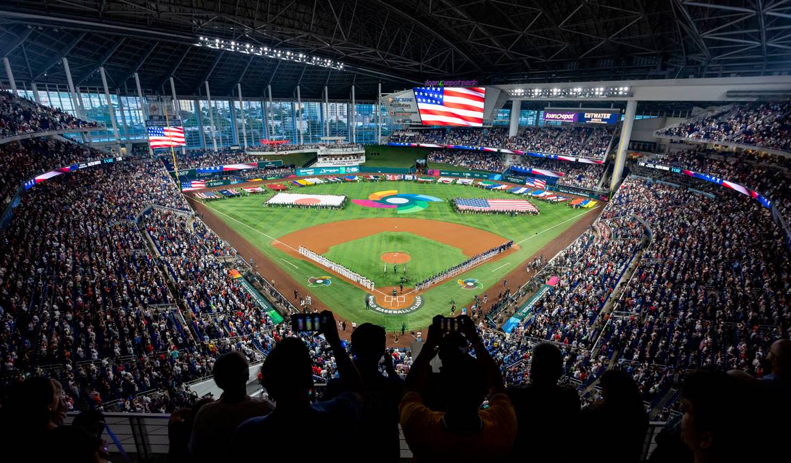 Fans stand for the national anthem before the start of a championship game between USA and Japan at the World Baseball Classic at loanDepot Park on Tuesday, March 21, 2023, in Miami, Fla.