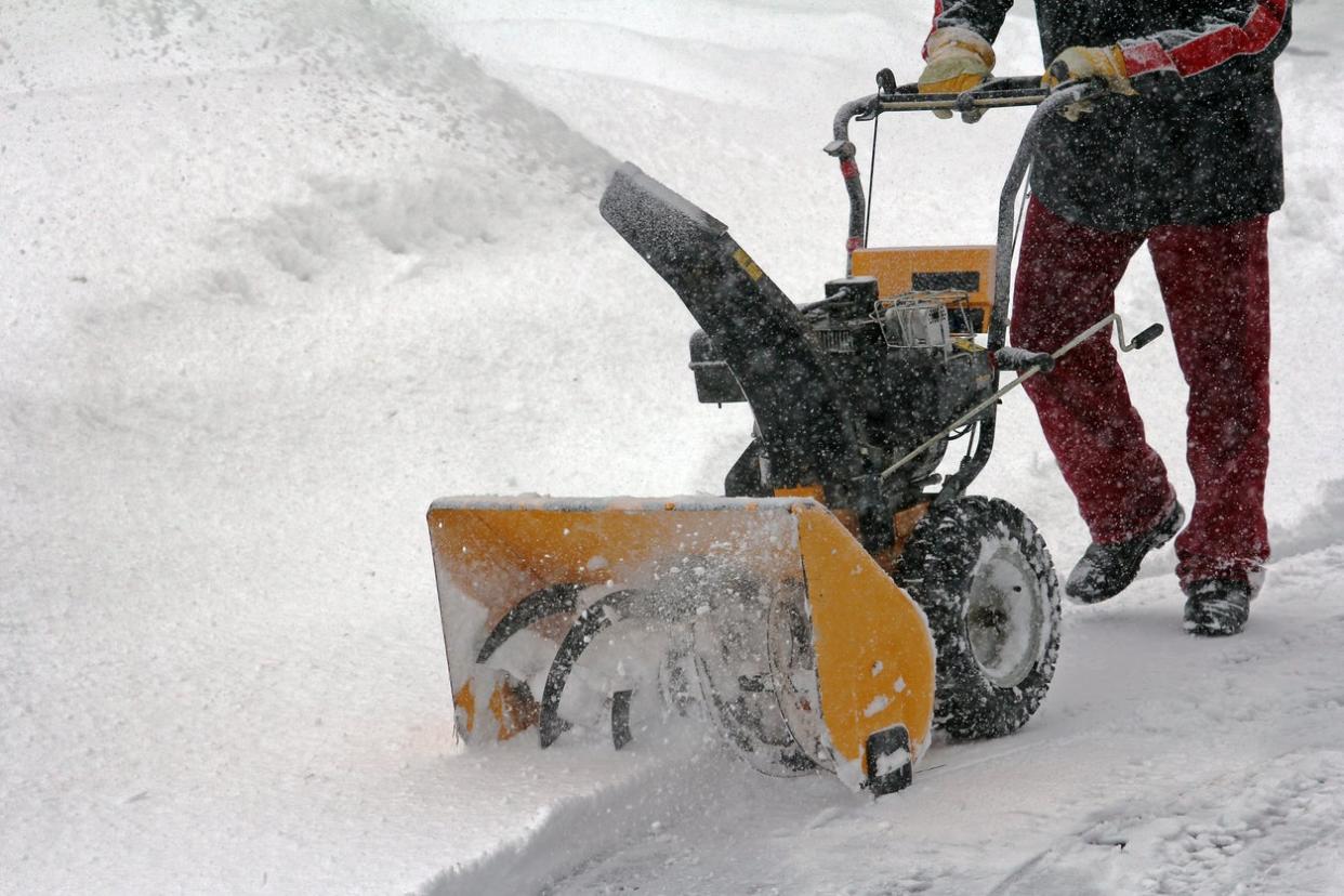 Man blowing snow.