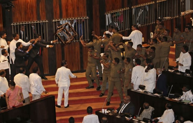 Legislators supporting Mahinda Rajapksa throw a chair  in parliament