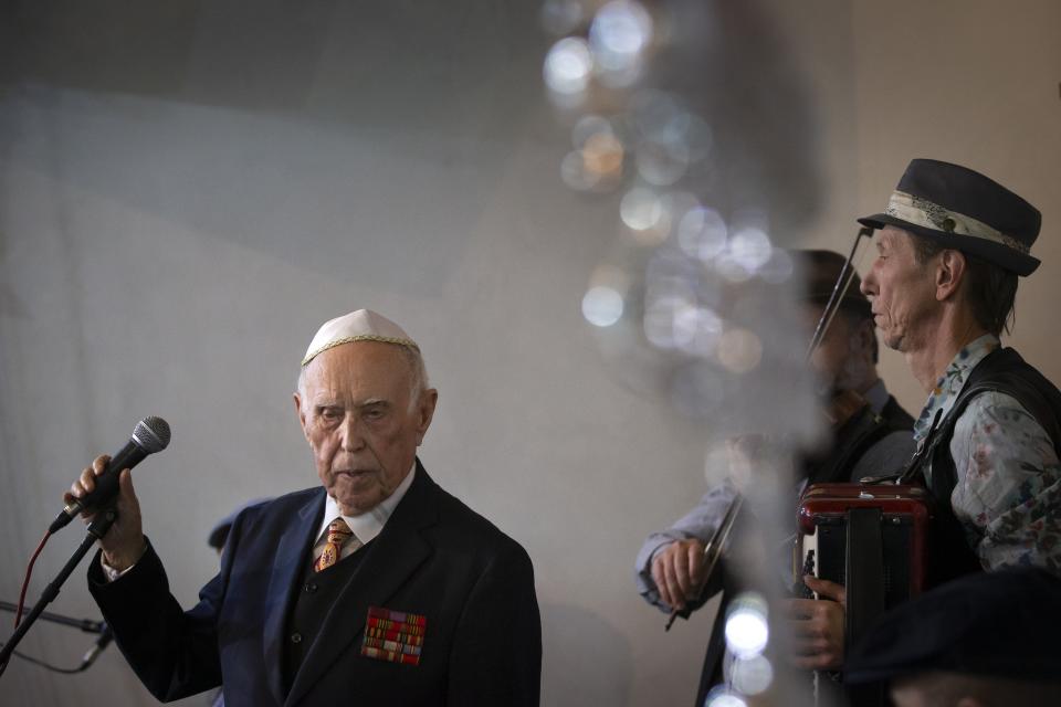 Holocaust survivor and WWII veteran Mikhail Spectr, 86, pauses as he speaks during the annual Hanukkah Menorah Lighting Ceremony in Moscow, Russia, Sunday, Dec. 22, 2019. Spectr was taken to Jewry in 1941 at the age of 8 when Nazi soldiers arrived at his village in Ukraine Soviet republic. Mikhail Spectr had been kept at ghetto in Transnistria, territory between Dniester and Southern Bug, occupied by the Nazi and its allies from 1941 and 1944. (AP Photo/Alexander Zemlianichenko)