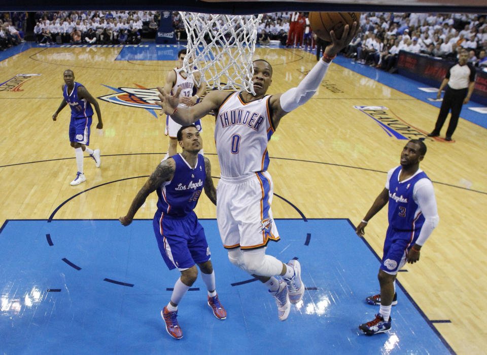 Oklahoma City Thunder guard Russell Westbrook (0) shoots between Los Angeles Clippers forward Matt Barnes (22) and guard Chris Paul (3) in the second quarter of Game 5 of the Western Conference semifinal NBA basketball playoff series, in Oklahoma City on Tuesday, May 13, 2014. (AP Photo)