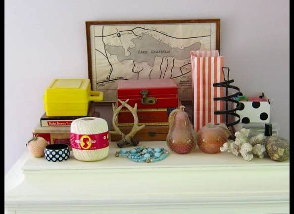 This is a pretty tablescape in Rosen's bedroom. She started with a few pieces, and has slowly added to the collection, giving away elements as gifts when she needs to edit or change them out.  The map is of Lake Garfield where she spent many occasions as a child. 