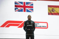 Mercedes driver Lewis Hamilton of Britain stand at the podium after winning the Qatar Formula One Grand Prix. In Lusail, Qatar, Sunday, Nov. 21, 2021. (Hamad I Mohammed, Pool via AP)