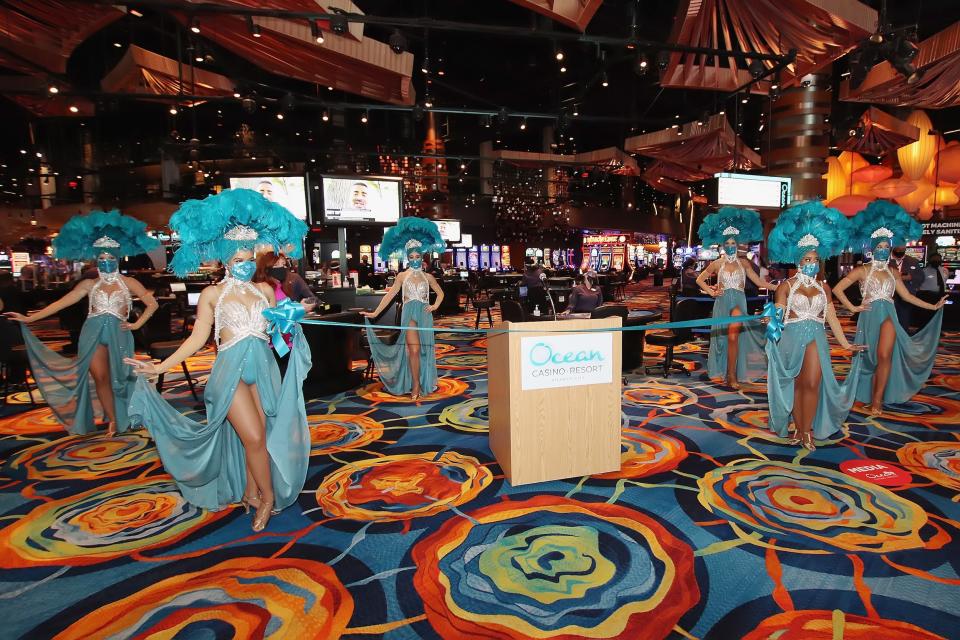 Models appear on the casino floor at Ocean Resort Casino during the property's reopening