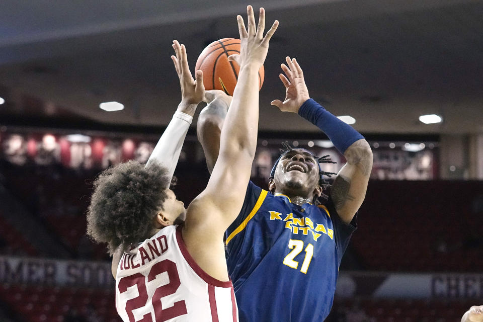 Kansas City guard RayQuawndis Mitchell (21) shoots as Oklahoma guard C.J. Noland (22) defends, in the first half of an NCAA college basketball game, Tuesday, Dec. 6, 2022, in Norman, Okla. (AP Photo/Sue Ogrocki)