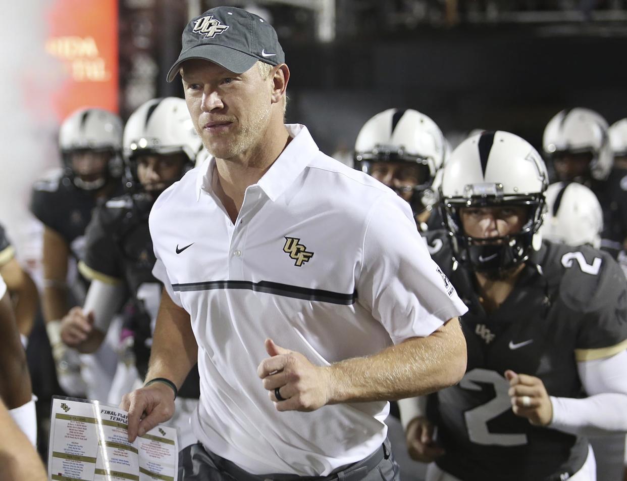In this Oct. 15, 2016, file photo, Central Florida coach Scott Frost leads his team onto the field for an NCAA college football game against Temple in Orlando, Fla. (Stephen M. Dowell/Orlando Sentinel via AP, File)