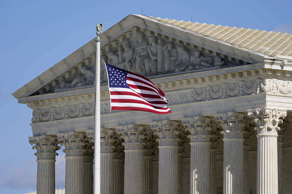FILE - An American flag waves in front of the Supreme Court building on Capitol Hill in Washington, on Nov. 2, 2020. Days after the Supreme Court outlawed affirmative action in college admissions on June 29, 2023, activists say they will sue Harvard over its use of legacy preferences for children of alumni. (AP Photo/Patrick Semansky, File)