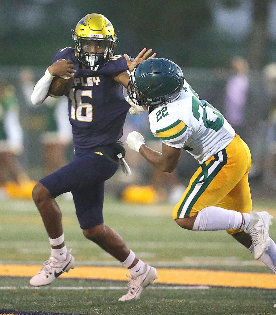 Copley quarterback Julian Bearshak fends of Firestone defender Dionte Younger during a third-quarter run Friday in Copley.