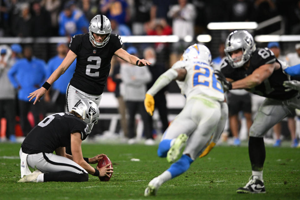 Jan 9, 2022; Paradise, Nevada, USA; Las Vegas Raiders kicker Daniel Carlson (2) kicks a game-winning field goal as time expired in overtime against the Los Angeles Chargers at Allegiant Stadium. Mandatory Credit: Orlando Ramirez-USA TODAY Sports