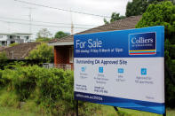 FILE PHOTO: A ÒFor SaleÓ sign is displayed in front of a row of houses in the suburb of Carlingford, Sydney, Australia February 1, 2019. REUTERS/Tom Westbrook