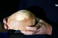 Dr. Omri Barzilai from the Israel Antiquities Authority displays a partial skull retrieved from a cave in northern Israel, in Jerusalem