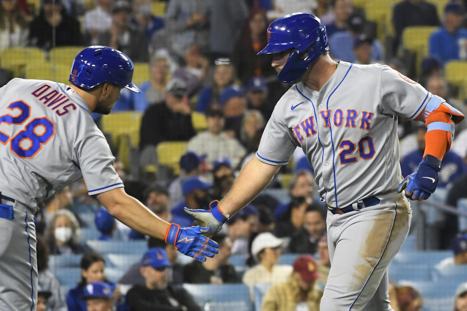 New York Mets' J.D. Davis, left, congratulates Pete Alonso on his home run against the Los Angeles Dodgers during the seventh inning of a baseball game Friday, June 3, 2022, in Los Angeles. (AP Photo/John McCoy)