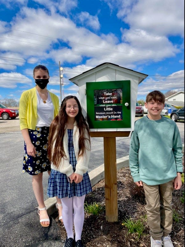 Emanuel United Church of Christ confirmands Tatum Sutton (left), Lillian Kindel and Nathan Weyand pose by the new micro food pantry known as The Blessing Box at the Doylestown church. Confirmation students helped build the box and decided what to stock in the pantry as part of their service project. The Blessing Box is available for those with grocery needs.