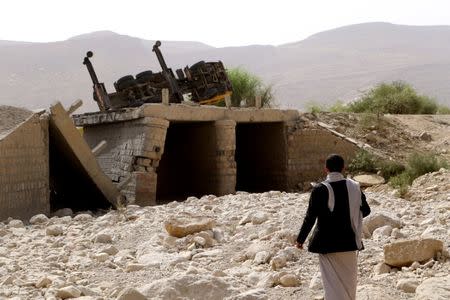 A man inspects damage of an airstrike on a truck in the northwestern city of Saada, Yemen June 21, 2018. REUTERS/Naif Rahma