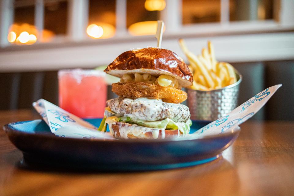 The S’Mac Burger comes from Newport's Surf Club and features a beef patty topped with three-cheese Mac 'n' Cheese, fried onion ring, Bibb lettuce and pickles. It's served on a toasted pretzel bun.