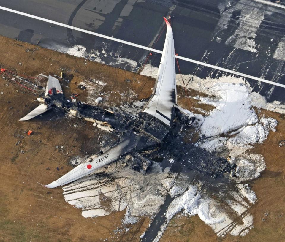 An aerial view shows burnt Japan Airlines’ (JAL) Airbus A350 plane after a collision with a Japan Coast Guard aircraft at Haneda International Airport in Tokyo (via REUTERS)