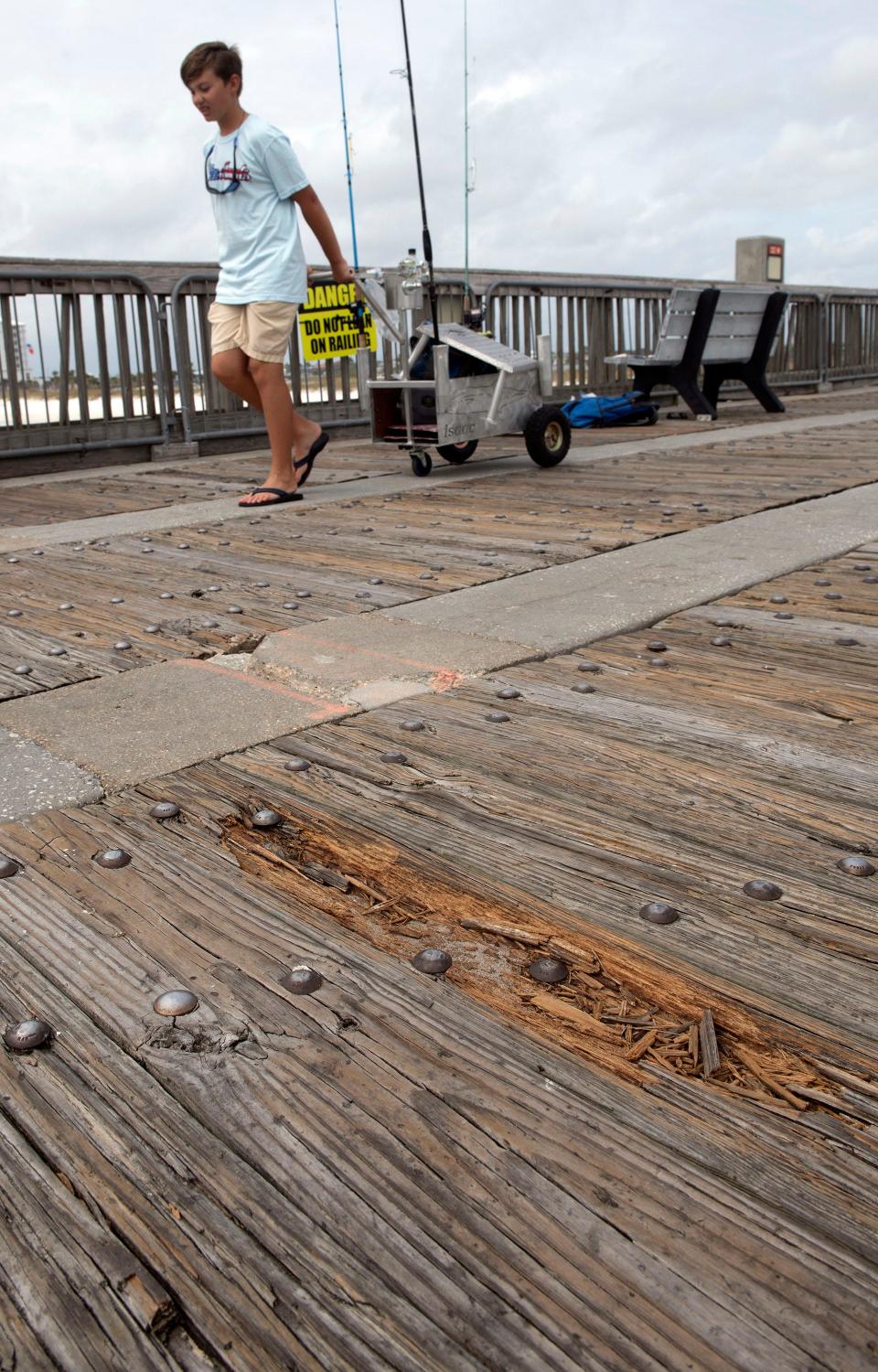 Angelers and sightseers use the worn and weathered Pensacola Beach Fishing Pier on Thursday, Oct. 5, 2023. Escambia County expects to begin work to repair broken and weathered portions of the Pensacola Beach Fishing Pier starting in November of 2023.