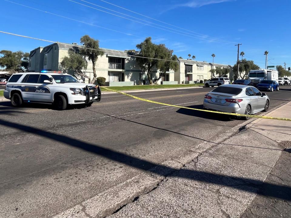 A Phoenix police vehicle on Dec. 15, 2023, blocks the eastbound lanes of Missouri Avenue after a search warrant was executed in an overnight shooting that left a woman dead and was believed related to a domestic dispute at the Missouri Crossing apartments.