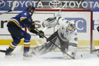 San Jose Sharks goaltender Devan Dubnyk (40) defends against St. Louis Blues' Carl Gunnarsson (4) during the first period of an NHL hockey game Monday, Jan. 18, 2021, in St. Louis. (AP Photo/Jeff Roberson)