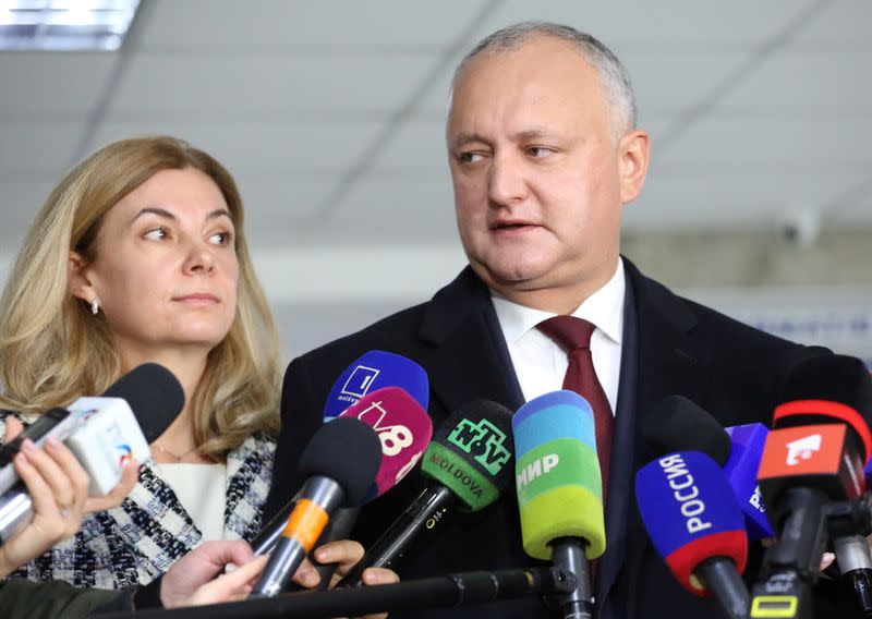 Igor Dodon, Moldova's President and presidential candidate, and his wife Galina visit a polling station during the second round of a presidential election in Chisinau