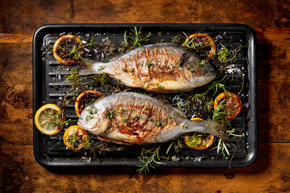 Grilled  fish with the addition of spices, herbs and lemon on the grill plate. (Getty Images/iStockphoto)