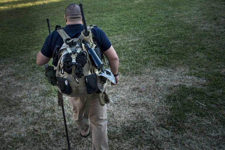 Jay Blevins walks to his backyard with a bug-out bag, containing about 40 pounds of survival gear on, December 5, 2012 in Berryville, Virginia. The Mayan end of the world is the last thing on Blevins' mind, but if it happens, he and his family are more than ready for it
