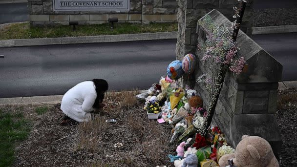 PHOTO: A woman pays her respects at a makeshift memorial for shooting victims outside the Covenant School building at the Covenant Presbyterian Church in Nashville, Tenn., March 28, 2023. (Brendan Smialowski/AFP via Getty Images)