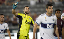 Vancouver Whitecaps goalkeeper Maxime Crepeau directs his teammates as players set up for a corner kick by the Colorado Rapids in the first half of an MLS soccer match Sunday, Sept. 19, 2021, in Commerce City, Colo. (AP Photo/David Zalubowski)